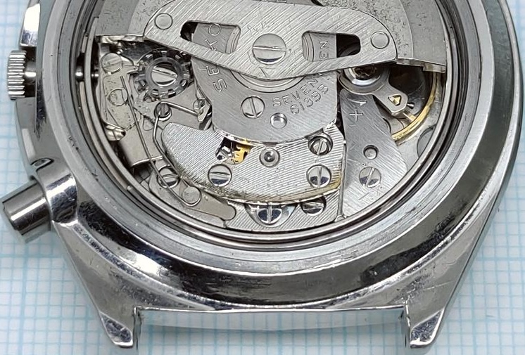 Seiko 6139 movement with the automatic rotor removed, showing the chronograph bridge where rotor wear appears